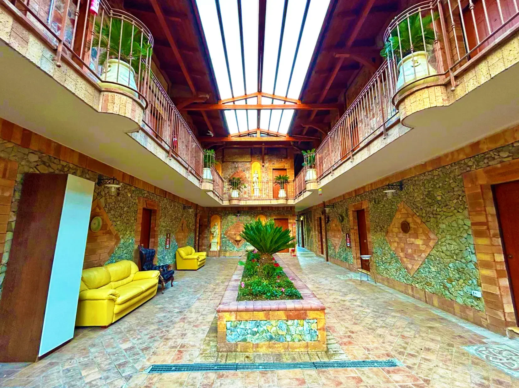 Il cortile luminoso con palme e divani